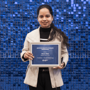 Simran Walia holding an award