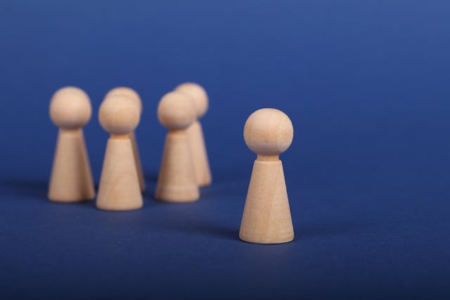 Wooden Person Figures on Blue Background